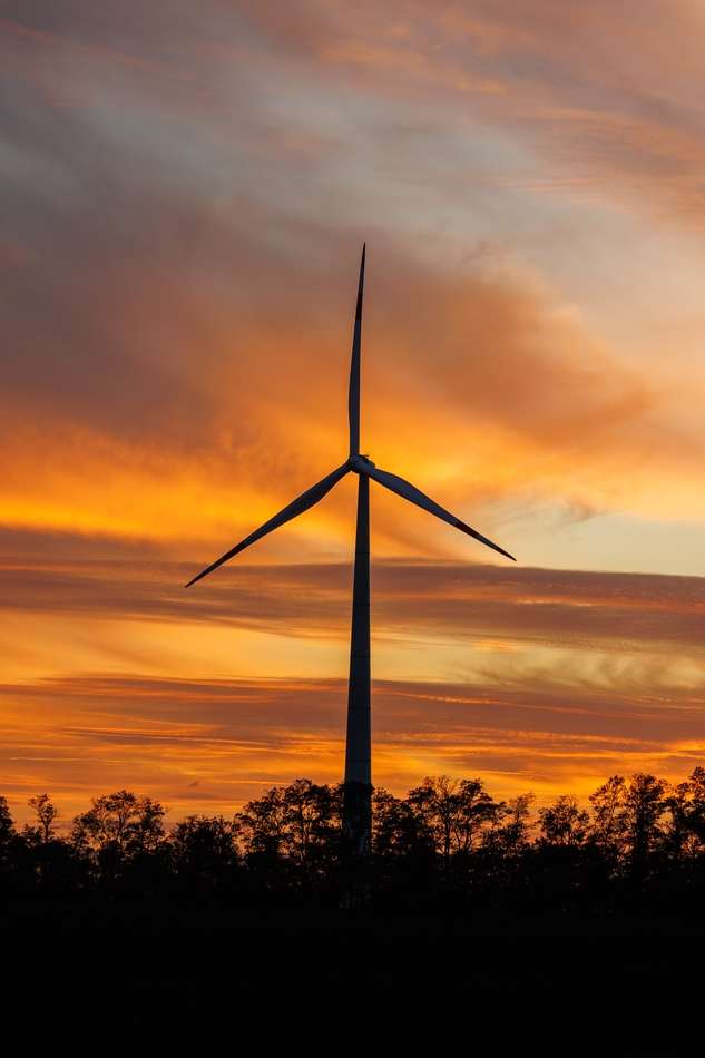 Wind turbine at sunset symbolizing recruitment and talent acquisition in the renewable energy sector.